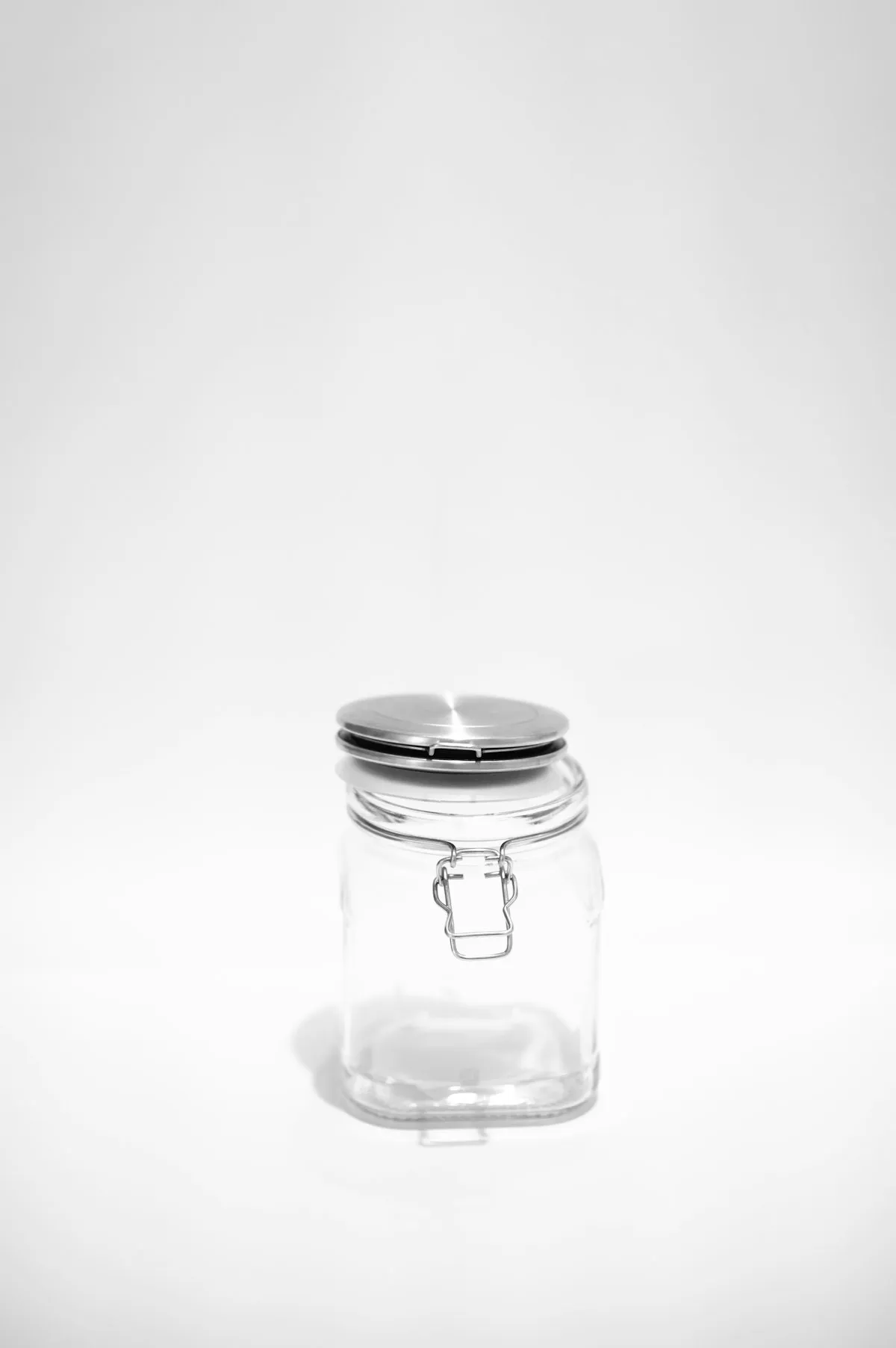 Tall clear mouth-blown apothecary jar with a domed lid